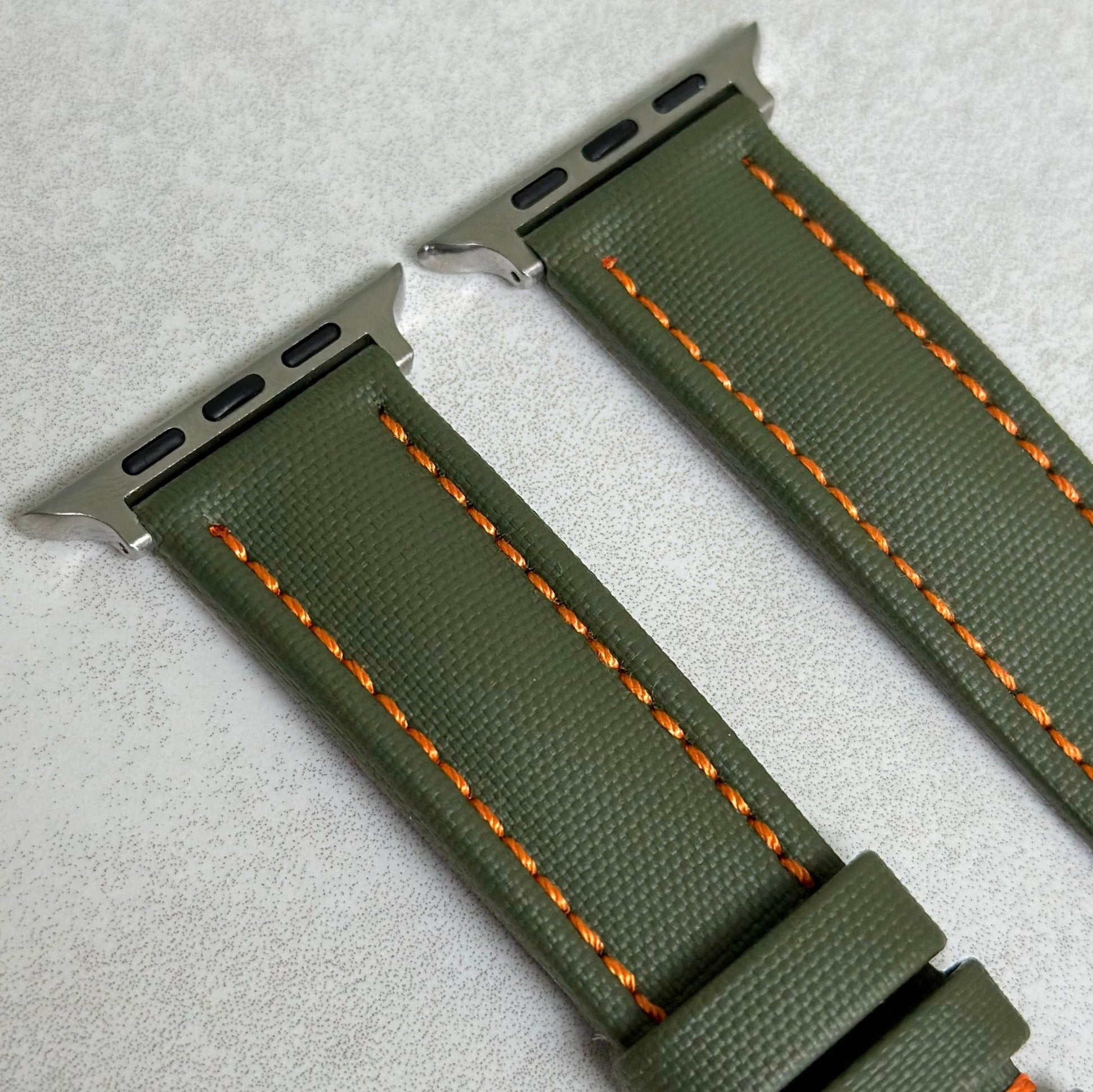 Top of the Bermuda khaki green sail cloth Apple Watch strap with orange stitching. Padded watch strap. Watch And Strap