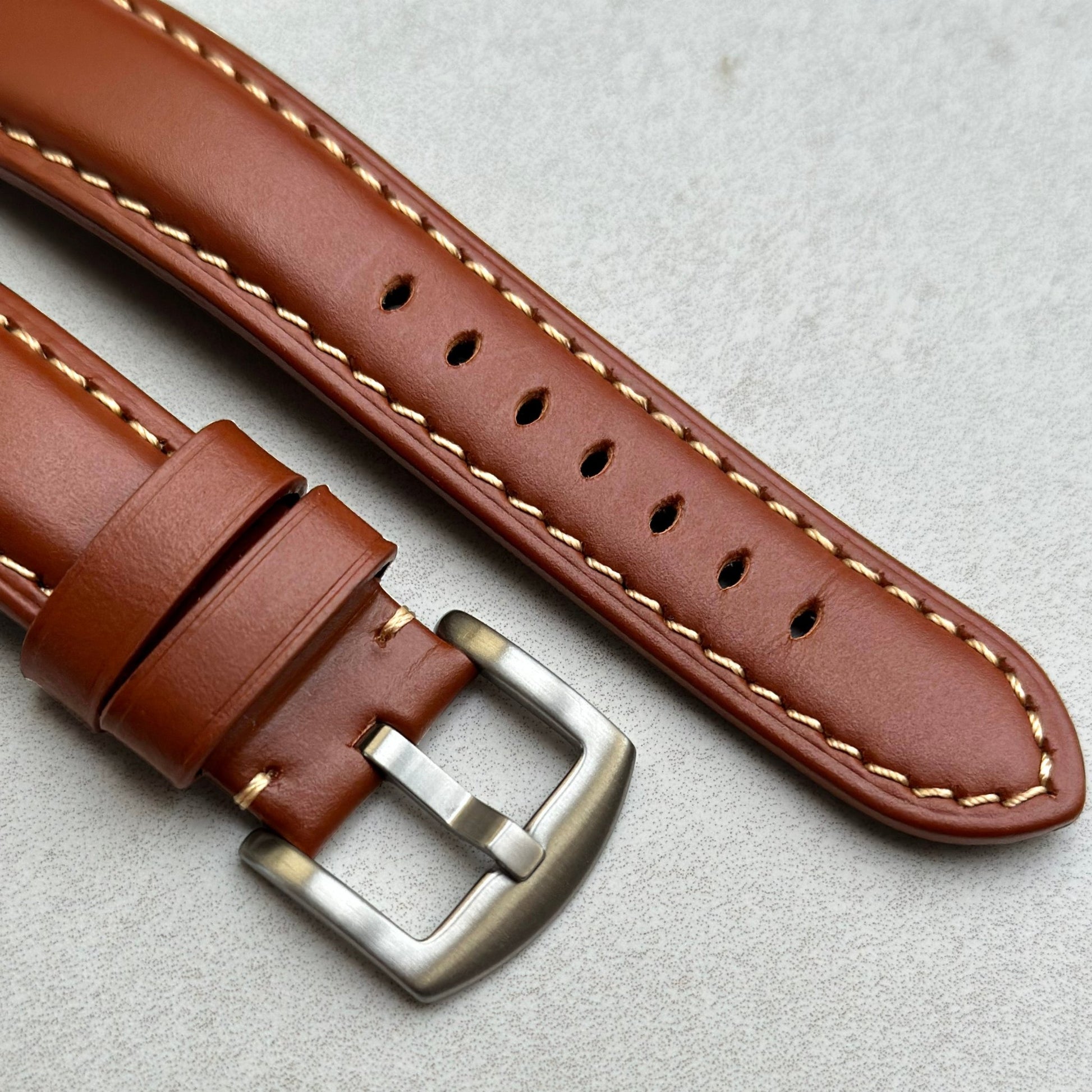 Brushed 316L stainless steel buckle on the Oslo brown full grain leather Apple Watch strap. Contrast ivory stitching.