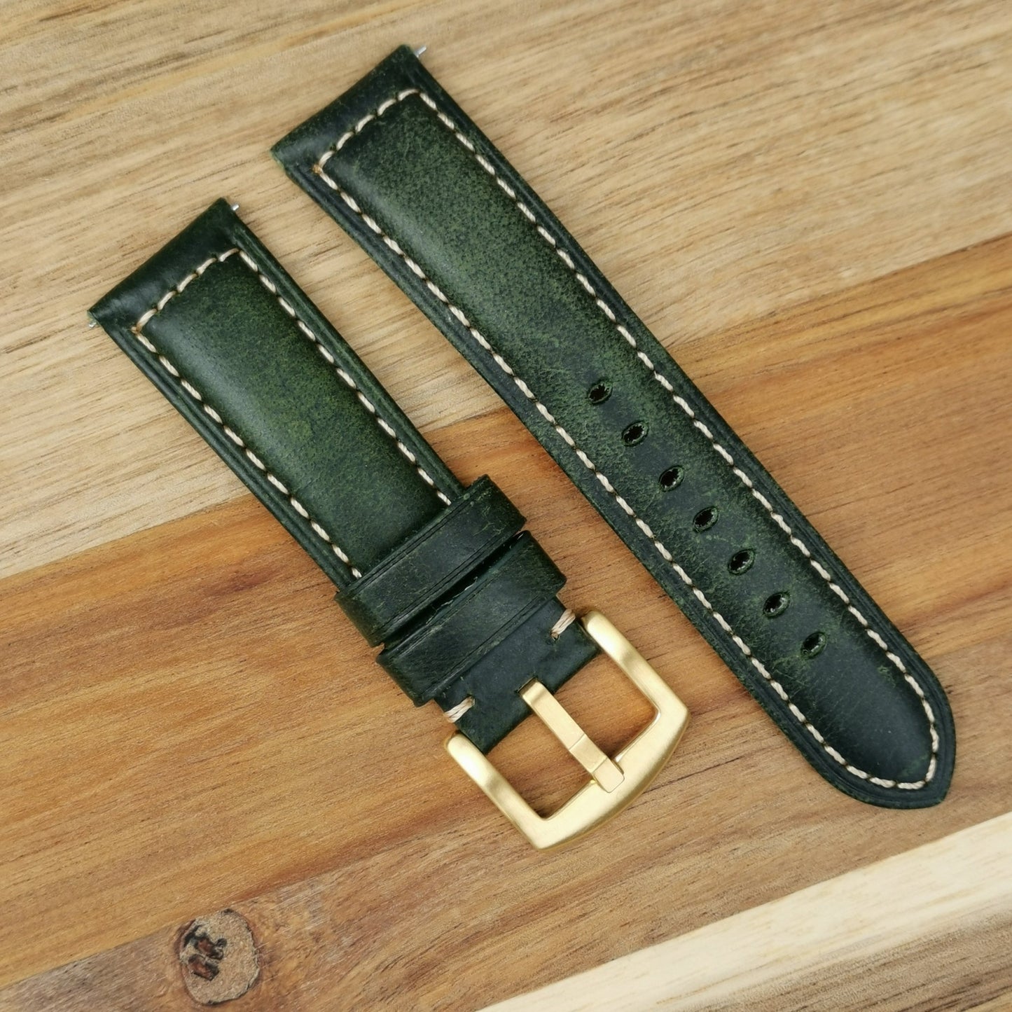 Berlin green full grain leather watch strap. Padded watch strap with a gold buckle and contrast ivory stitching.