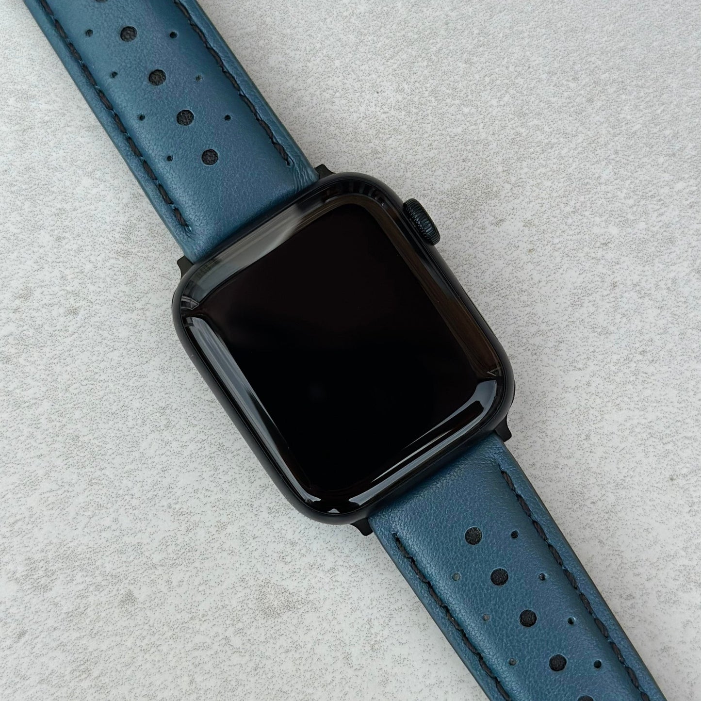 Le Mans petrol blue and black full grain leather apple watch strap on an Apple watch. 