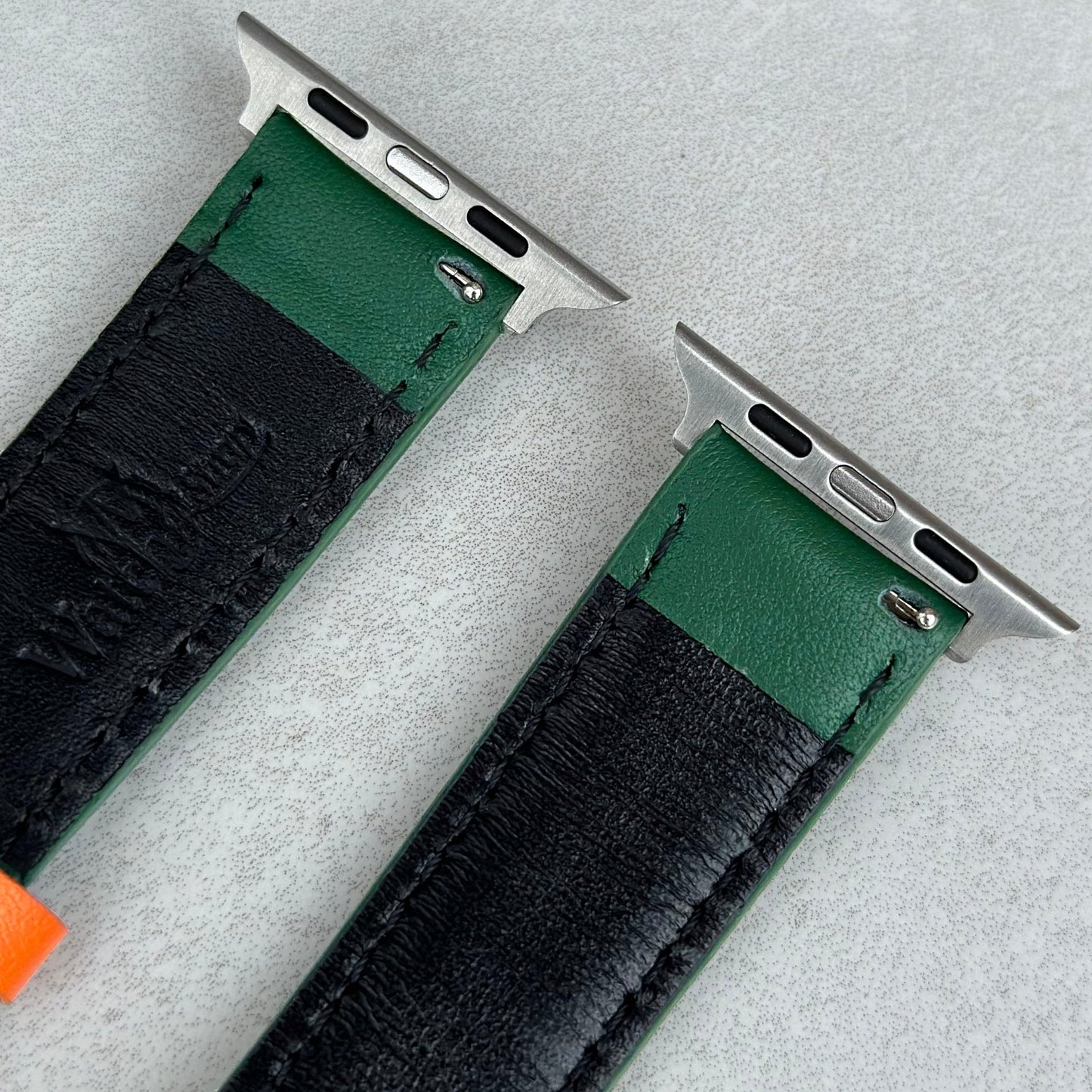 316L stainless steel connectors on the Le Mans green and orange full grain leather apple watch strap. Watch And Strap logo.