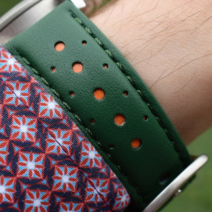 Wrist shot of the Le Mans green and orange leather racing watch strap. Handmade leather watch band.