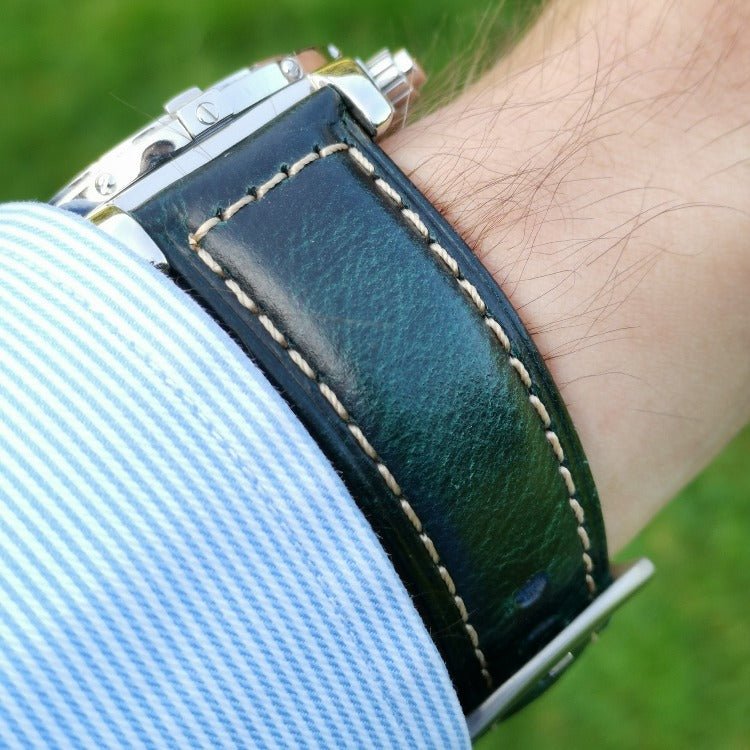 Wrist shot of Berlin blue full grain leather watch strap. Cracked electric blue leather and contrast light gold stitching.