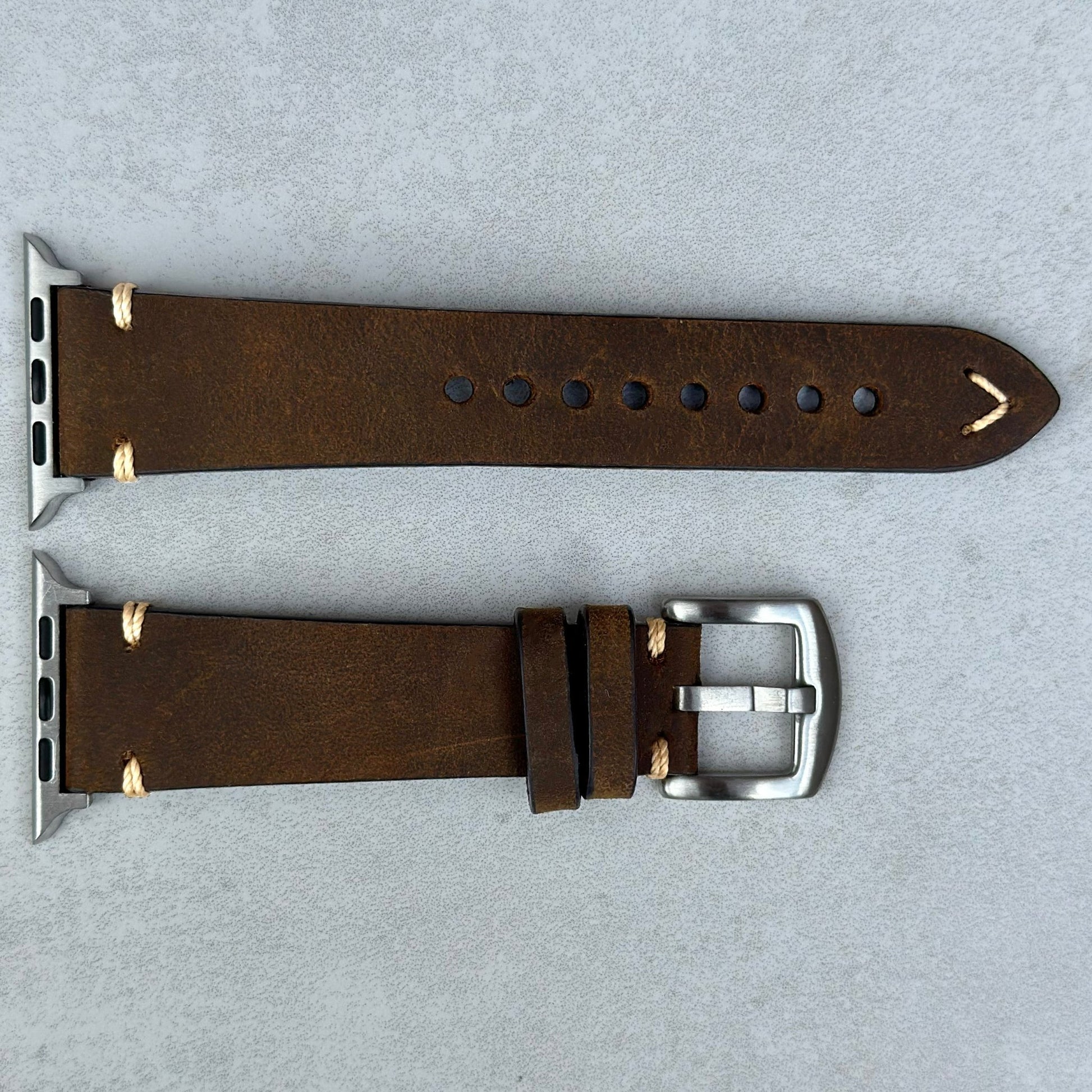 Chocolate brown full grain horse leather. Contrast ivory stitching. Stainless steel hardware. Apple Watch Strap.
