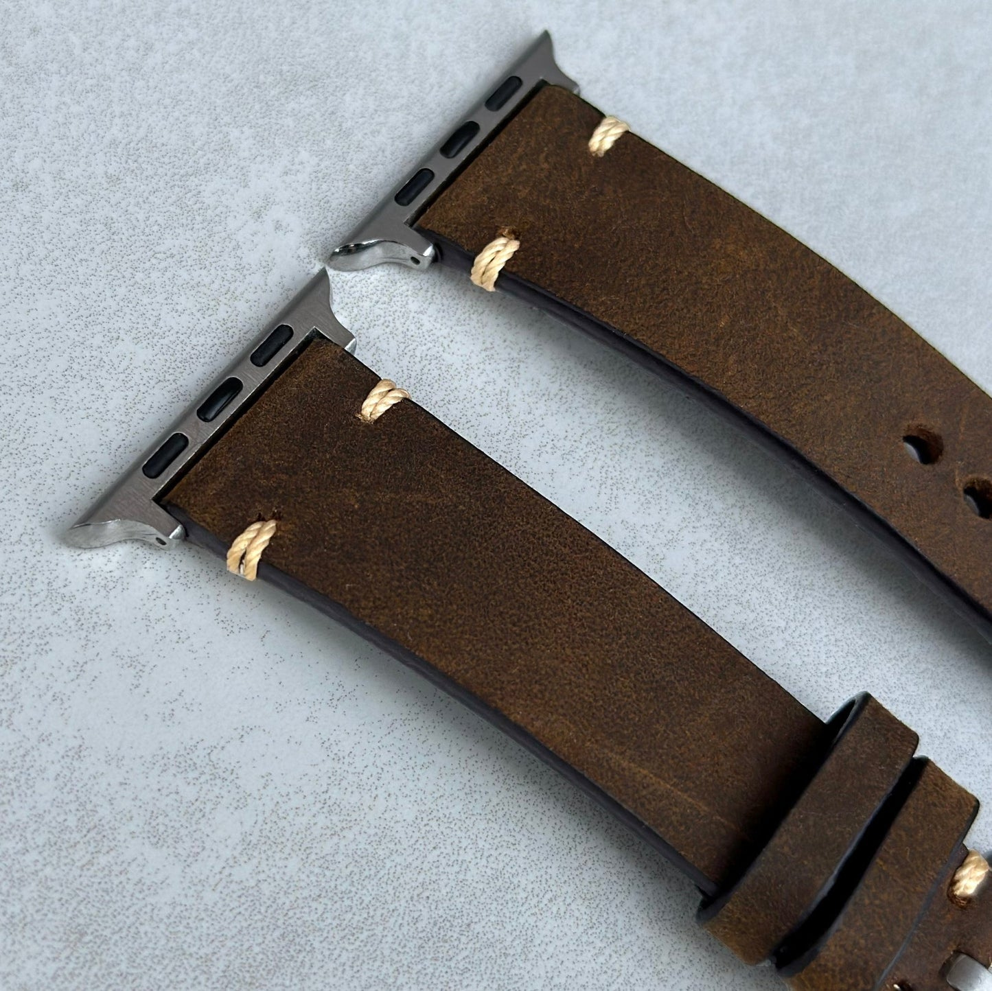 Top of the Madrid Chocolate Brown Apple Watch Strap. Ivory Stitching. 316L stainless steel hardware.