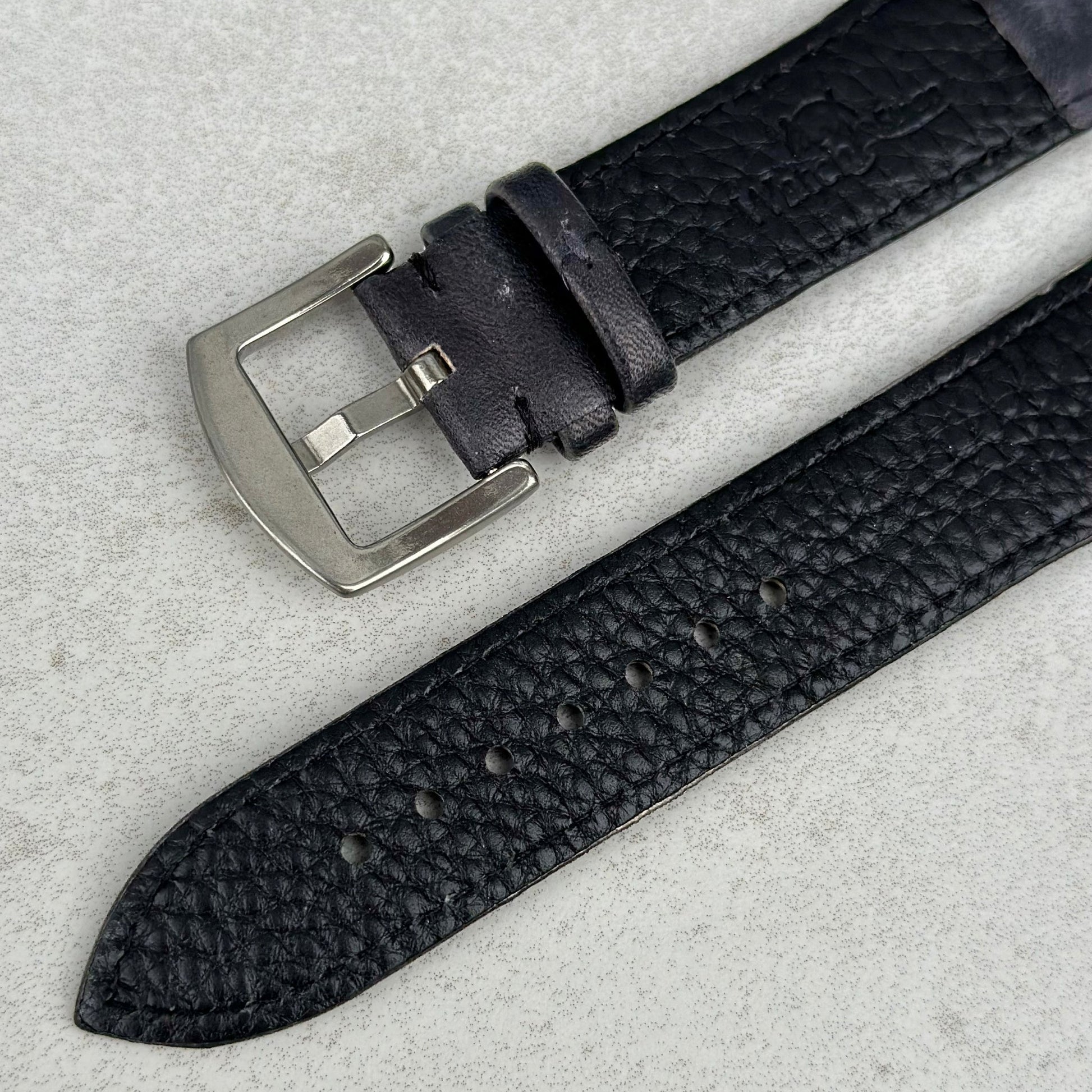 Underside buckle of the Milan black leather watch strap.