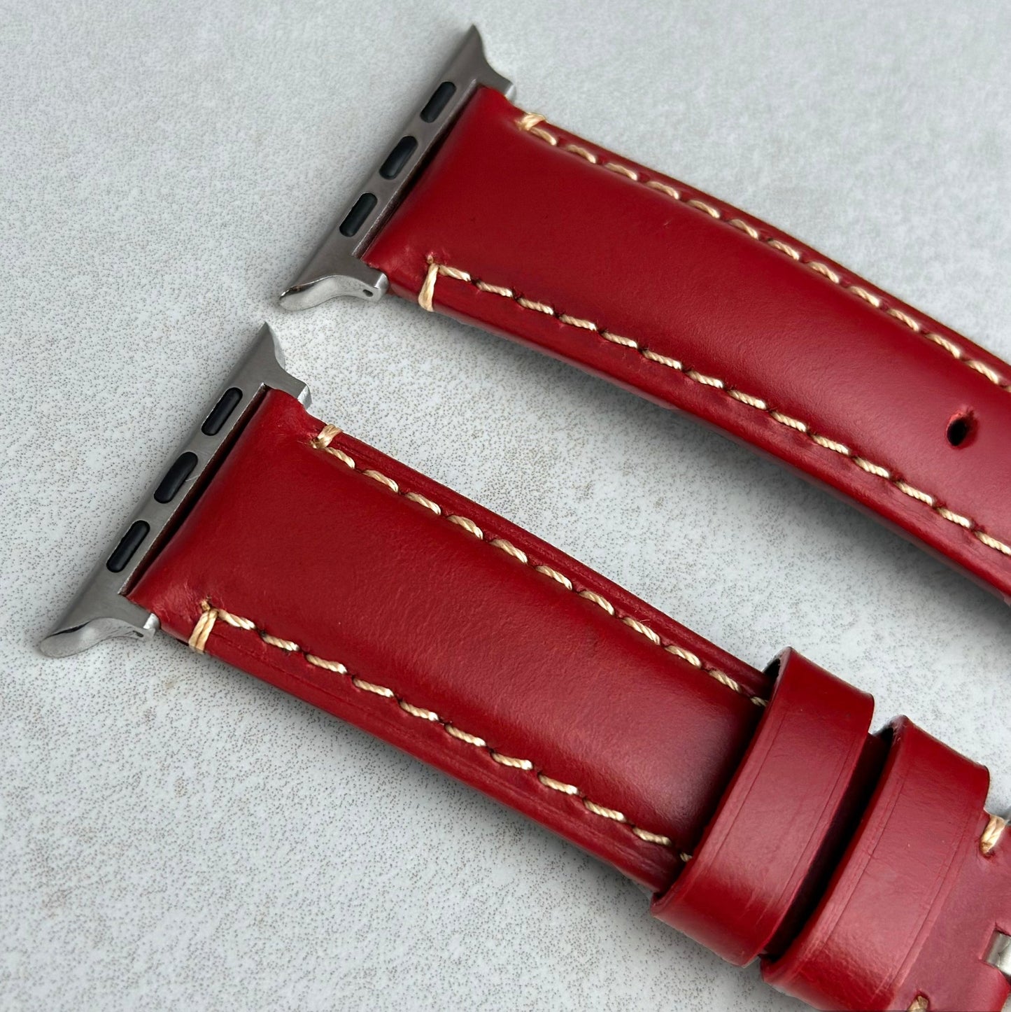 Top of the Oslo red full grain leather Apple Watch strap. Padded leather strap. Contrast ivory stitching. Watch And Strap.