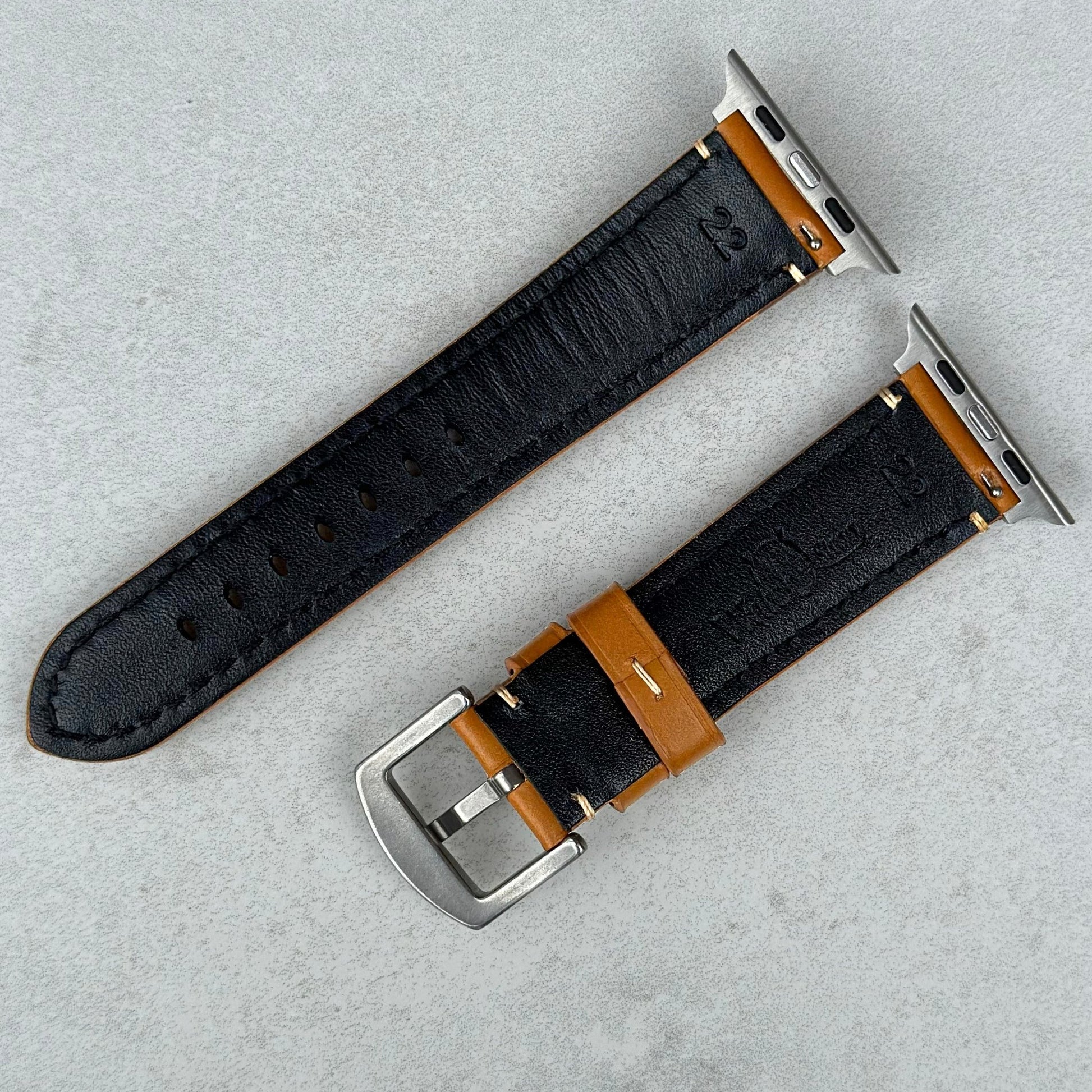 Underside of the Oslo tan full grain leather Apple Watch strap. Watch And Strap logo.