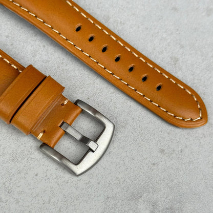 Brushed 316L stainless steel on the Oslo tan full grain leather Apple Watch strap.