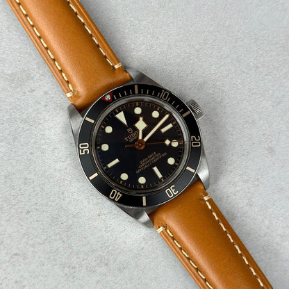 Oslo tan full grain leather watch strap on the Tudor Blackbay 58. Contrast ivory stitching. 18mm, 20mm, 22mm, 24mm.