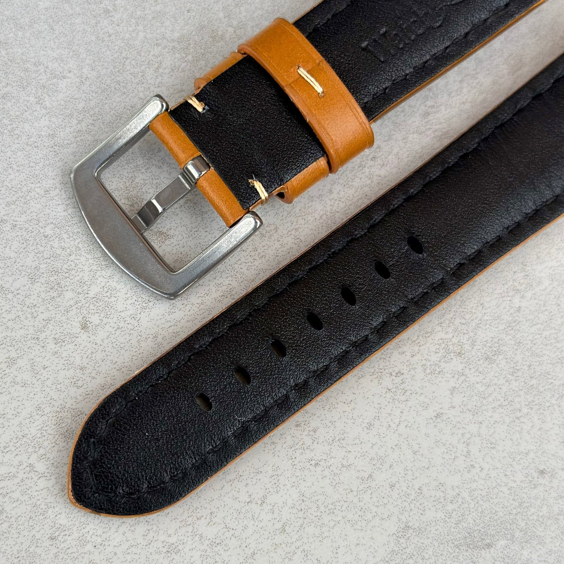 Underside of the brushed stainless steel buckle on the Oslo tan full grain leather watch strap. Watch And Strap
