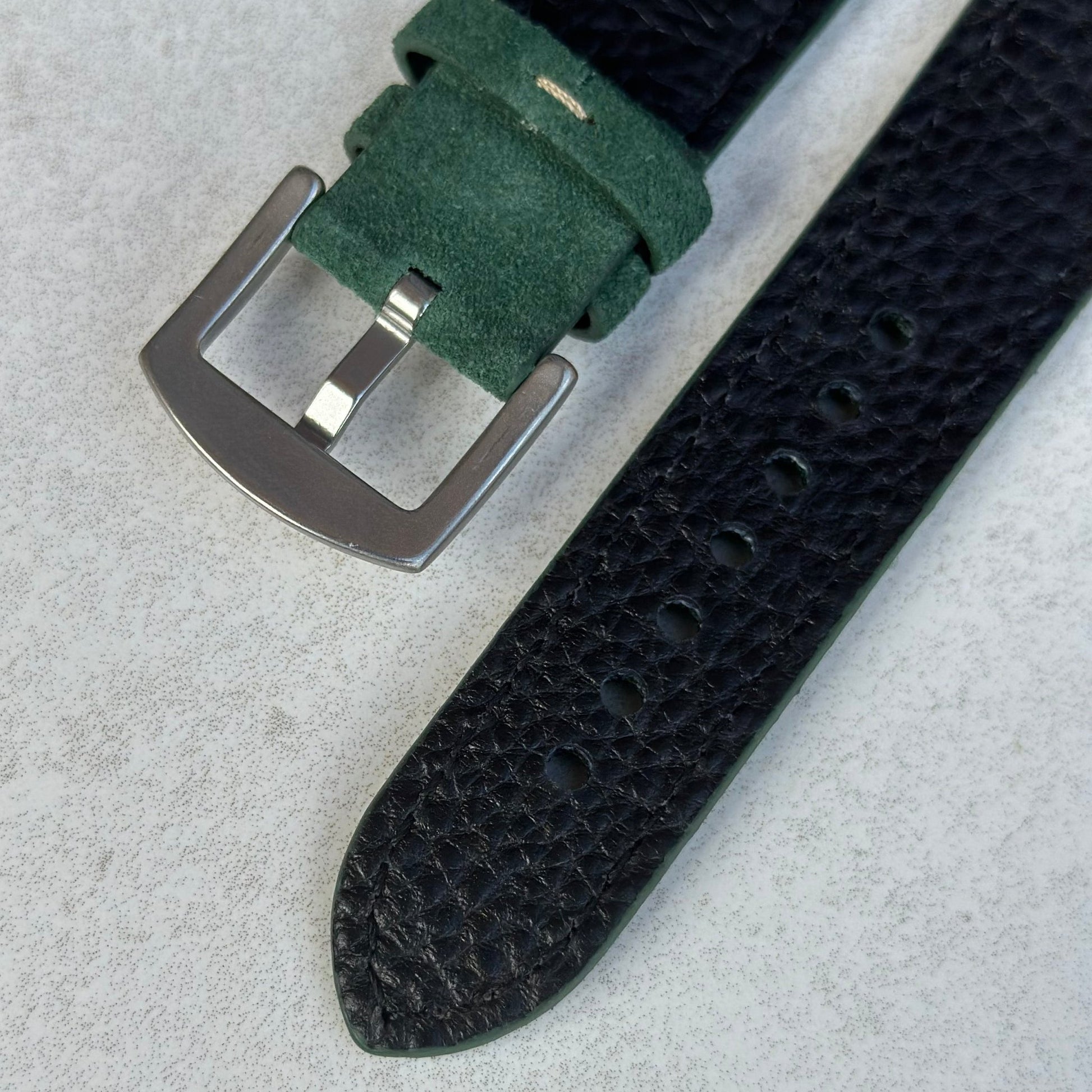 Stainless steel buckle on the hunter green suede Apple Watch strap.