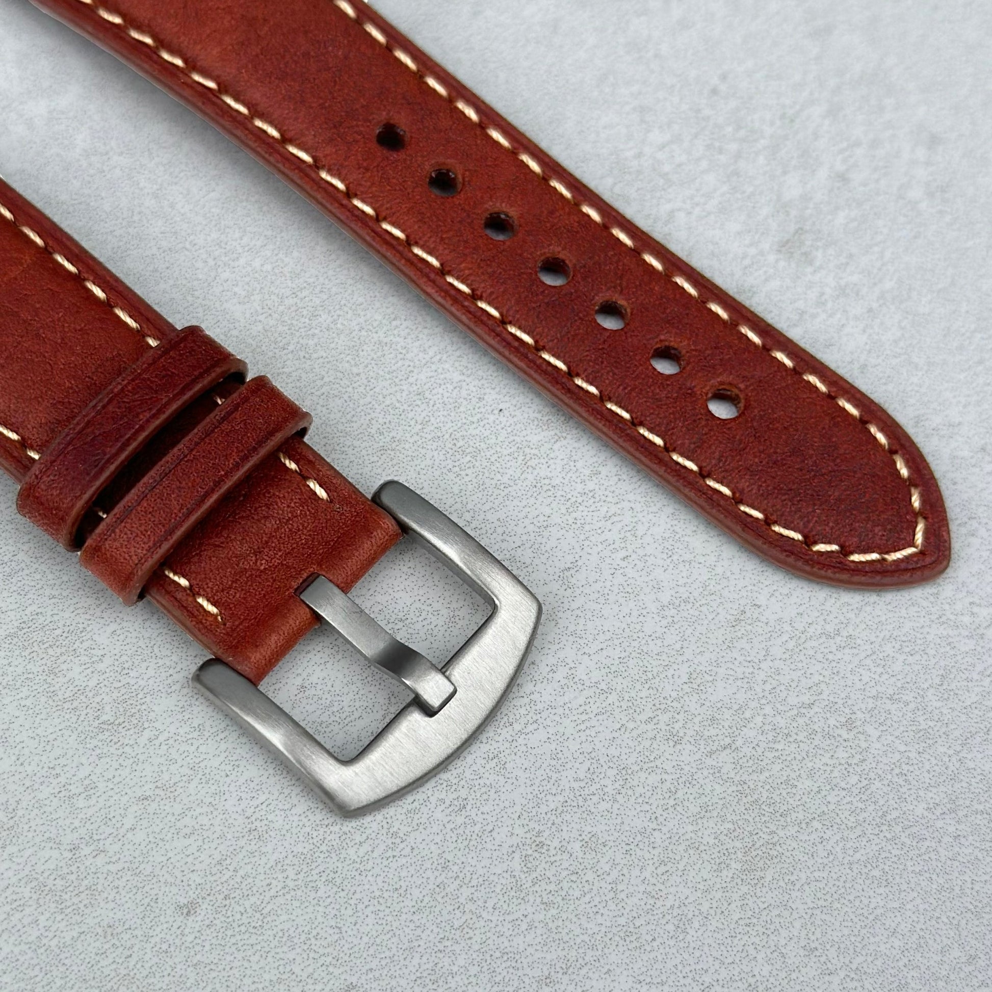 Brushed 316L stainless steel buckle on the terracotta brown Italian leather watch strap. Contrast ivory stitching.